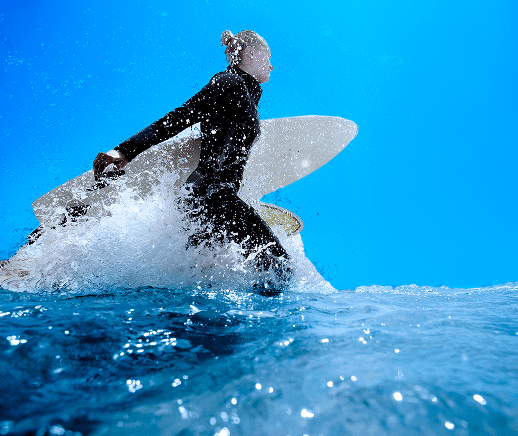 Person surfing on a large breaking wave